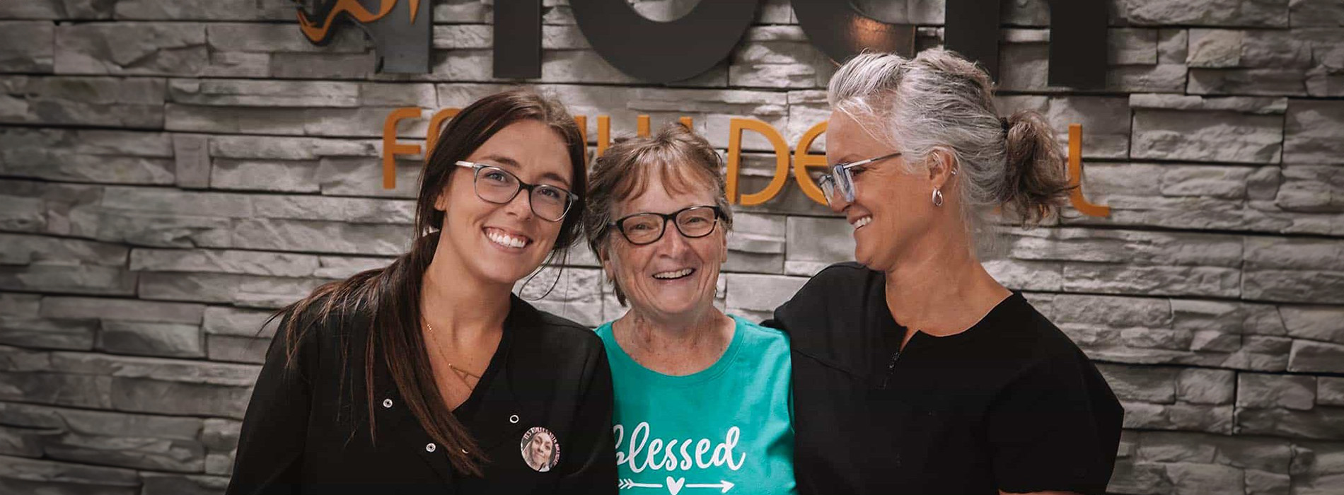 The image is a photograph of a woman with light skin, smiling at the camera. She appears to be in her late twenties or early thirties and has long hair. Her eyes are looking directly at the camera, and she is holding up her index finger near her mouth as if she s making a point or emphasizing something. The background is plain and light-colored, which suggests that this could be a stock photo used for various purposes such as advertising, personal branding, or lifestyle content.